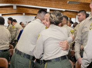 Cadet hugging each other after graduation.