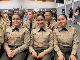 Three Cadets sitting in graduation.