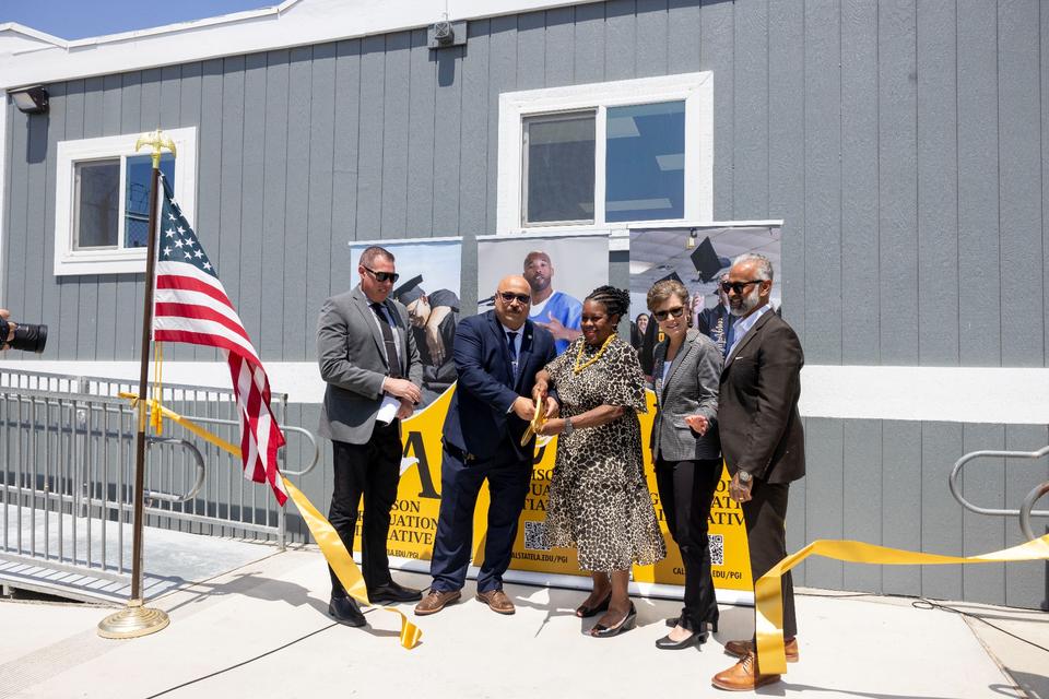 California Institution for Men's (CIM) Associate Director Travis Pennington, far left, and Warden Eric Mejia join Cal State LA President Berenecea Johnson Eanes, Provost Heather Lattimer, and Prison Graduation Initiative Director Bidhan Roy for the ribbon-cutting ceremony at the CIM College Campus on Tuesday, May 27.  (Credit: J. Emilio Flores/Cal State LA)