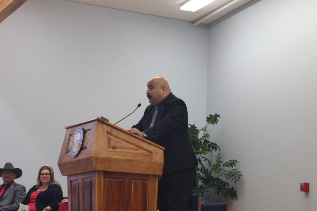 Acting Warden Eric Mejia speaking at podium