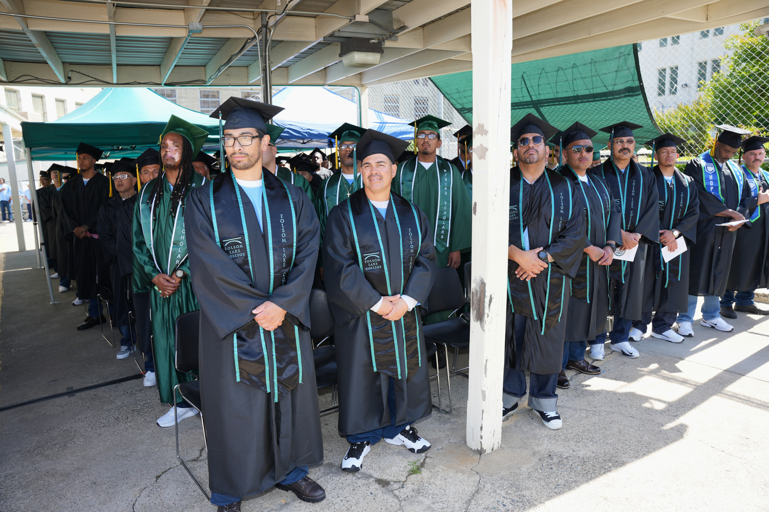 A picture from a graduation event featuring incarcerated people from Folsom State Prison who graduated from a program through Folsom Lake College.
