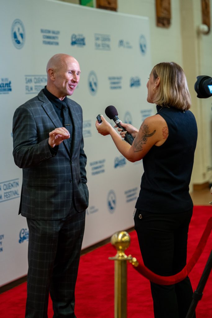 San Quentin Rehabilitation Center Warden Andes being interviewed on the red carpet
