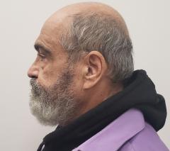 Side mugshot image of John Gilbert Deluca