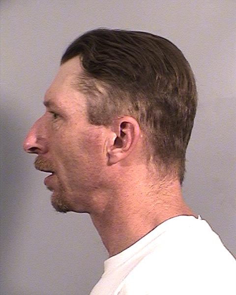 Side mugshot image of Christopher Shawn Benefield