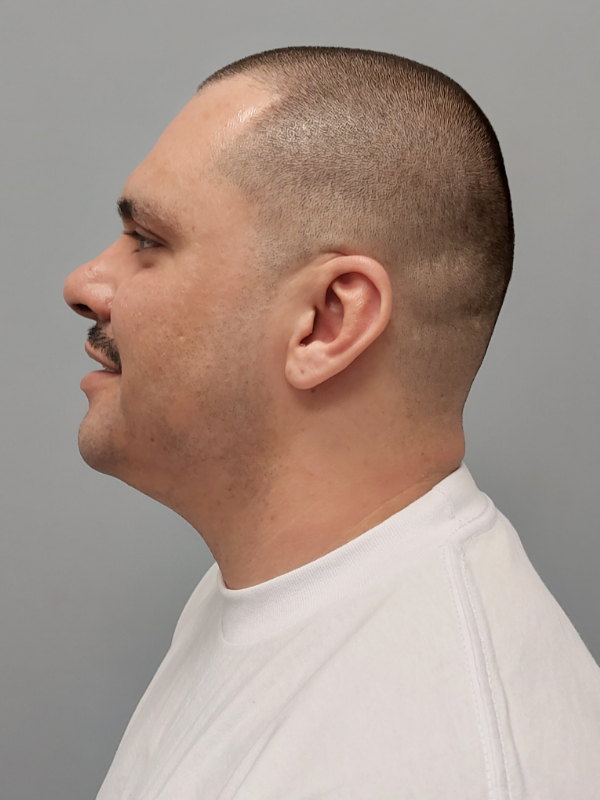 Side mugshot image of Miguel Angel Huezo