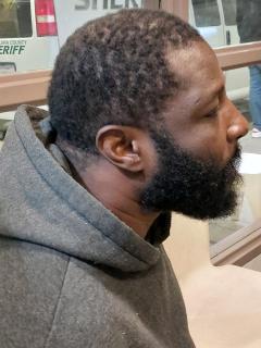 Side mugshot image of Abu B Ghazali