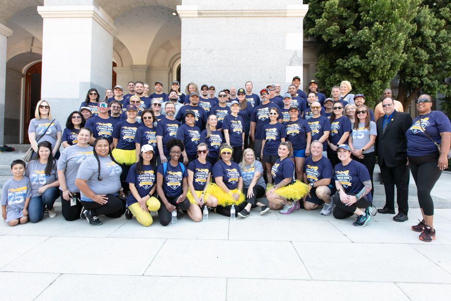 Large group of CDCR employees in Law Enforcement Torch Run shirts at the California State Capitol.