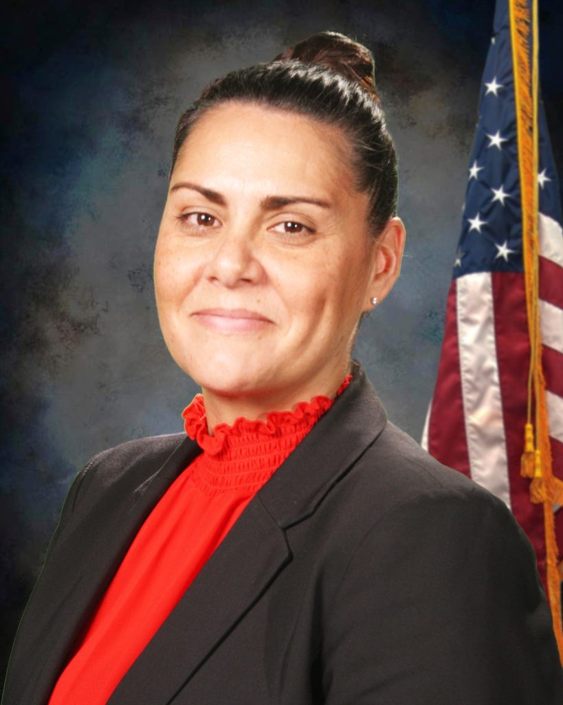 Headshot of Tammy Campbell with American flag behind her.