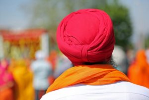 The back of a man wearing a red turban