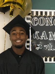 A young man in a graduation cap and gown