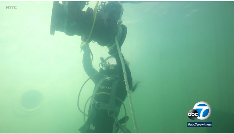 A diver welds equipment underwater.