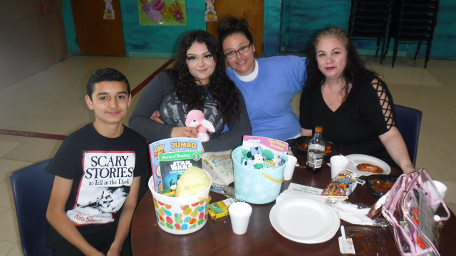 An incarcerated women with her family, they are at a table with Easter decorations