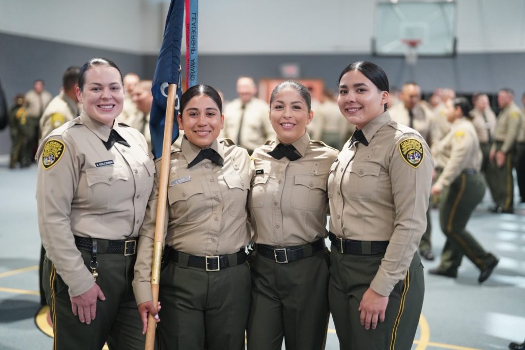 Four female correctional officers in uniform.