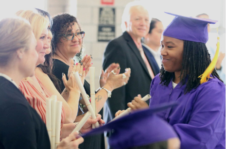 graduate shaking hands with staff