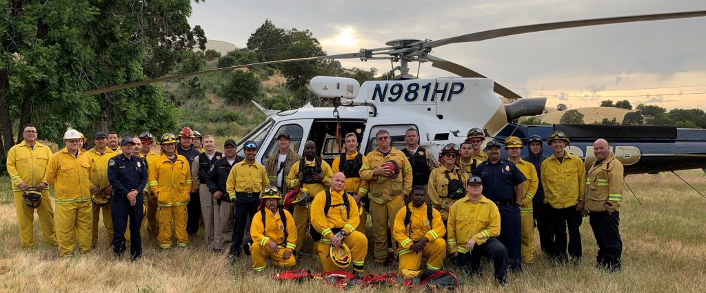 CMF fire crew standing with helicopter