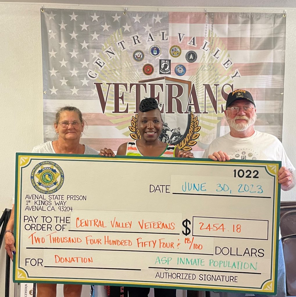 veterans holding a check