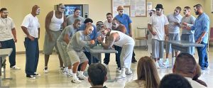 ASP incarcerated in face paint performing an act for their program