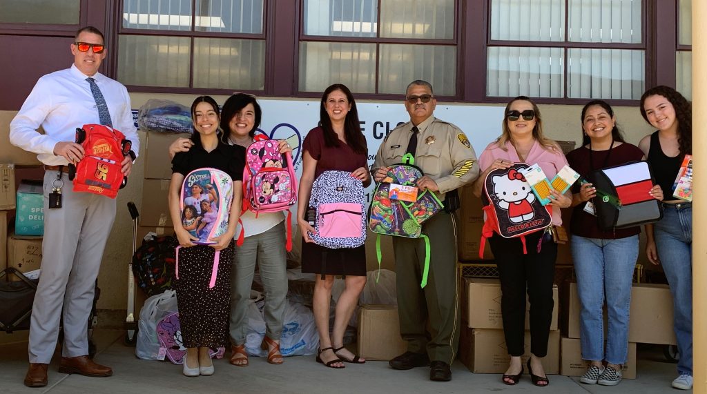 CIM staff with backpacks for students
