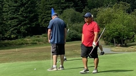 three men standing on green at PBSP golf tournament