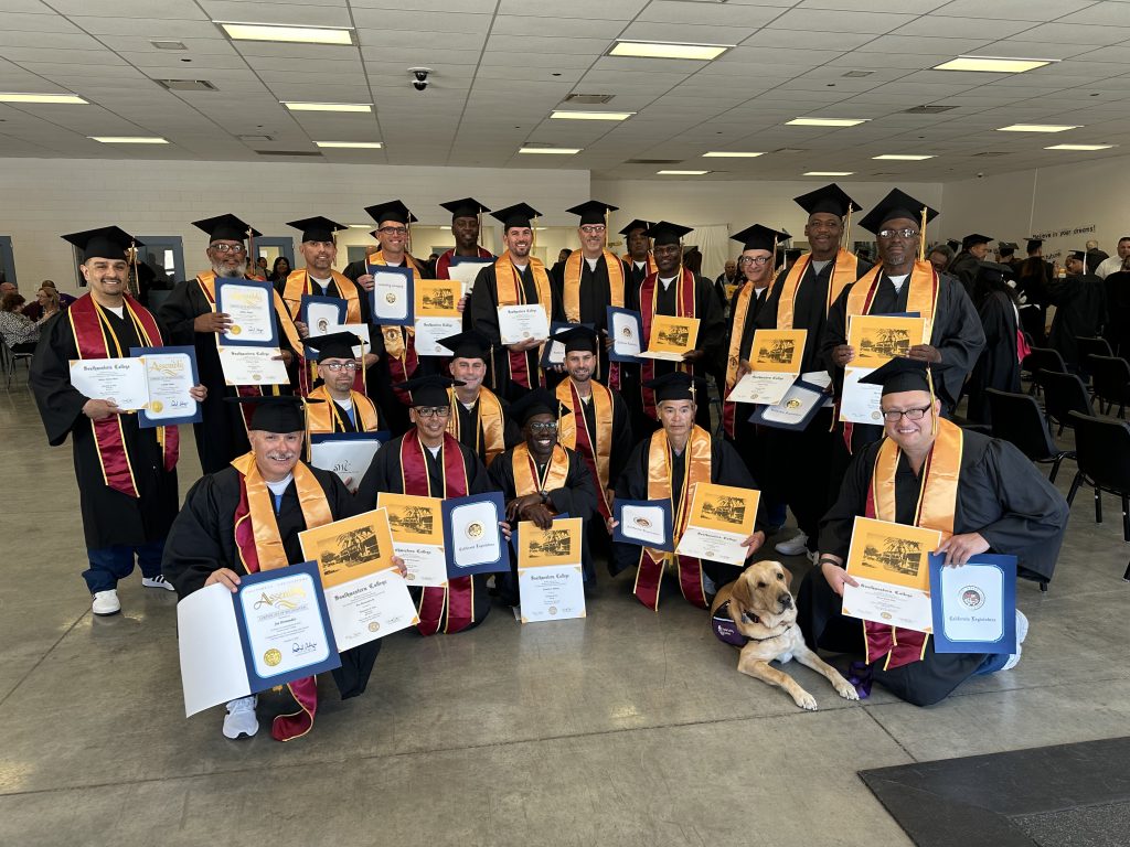 A group of graduates hold their diplomas