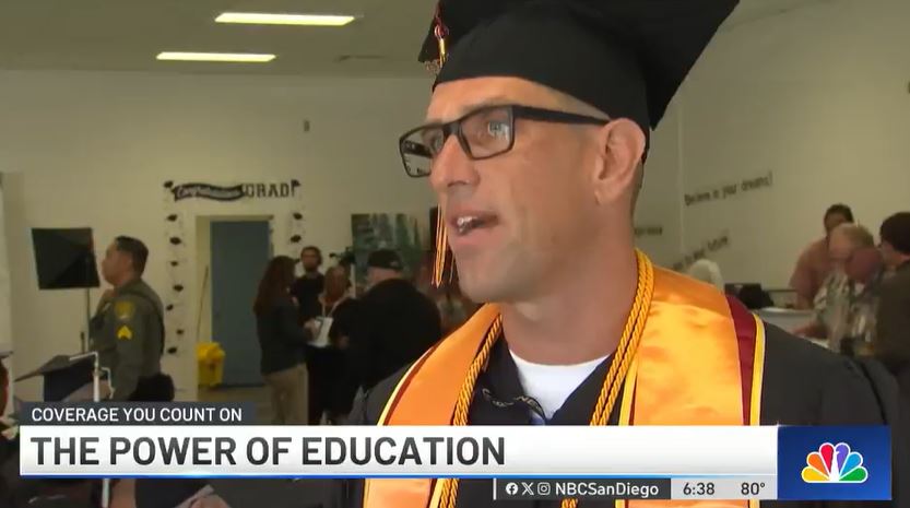An incarcerated man in a graduation cap and gown