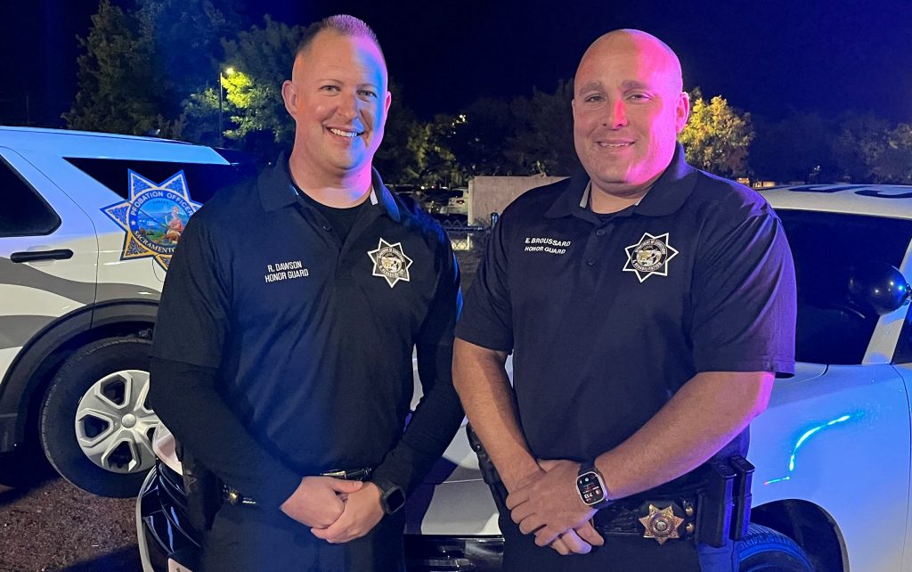 Two officers in black polo shirts.