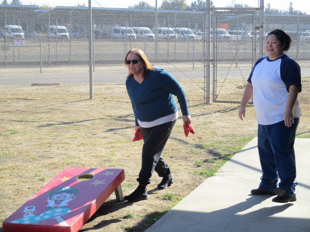 incarcerated and a mother play cornhole