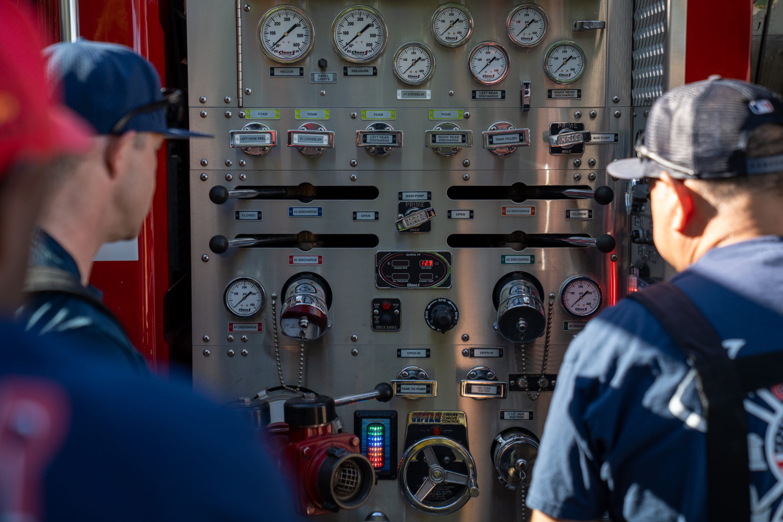 firefighters observing fire engine during fire training